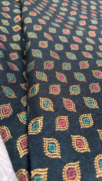 Close-up of patterned fabric with geometric design on a dark background